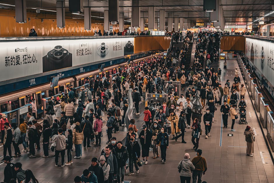 Overhead view of a bustling crowd at a metro station platform in Taipei, Taiwan.